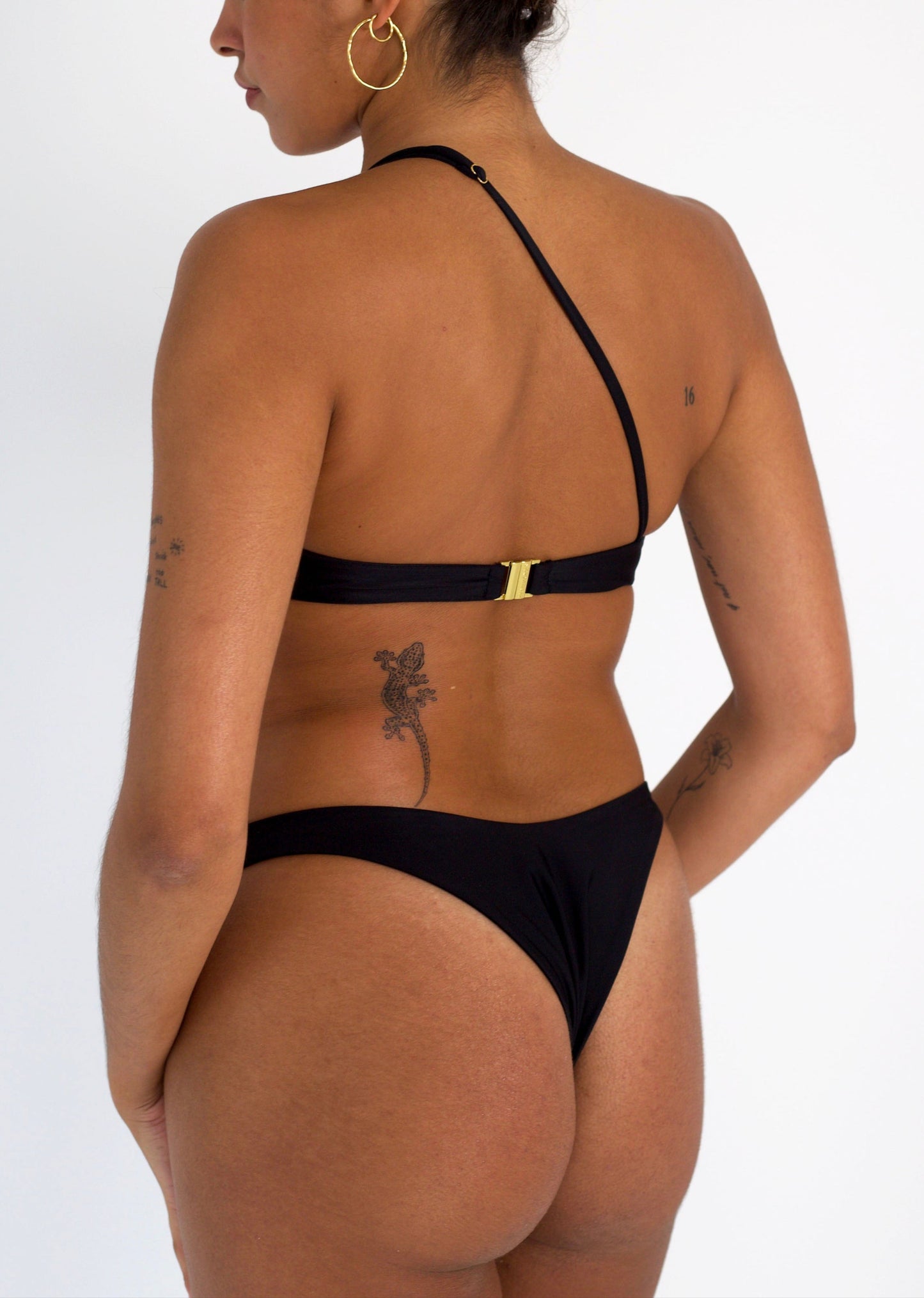 Leah Loves Ivy Asymmetric Bikini Top in Black with Gold Hardware - Back Side