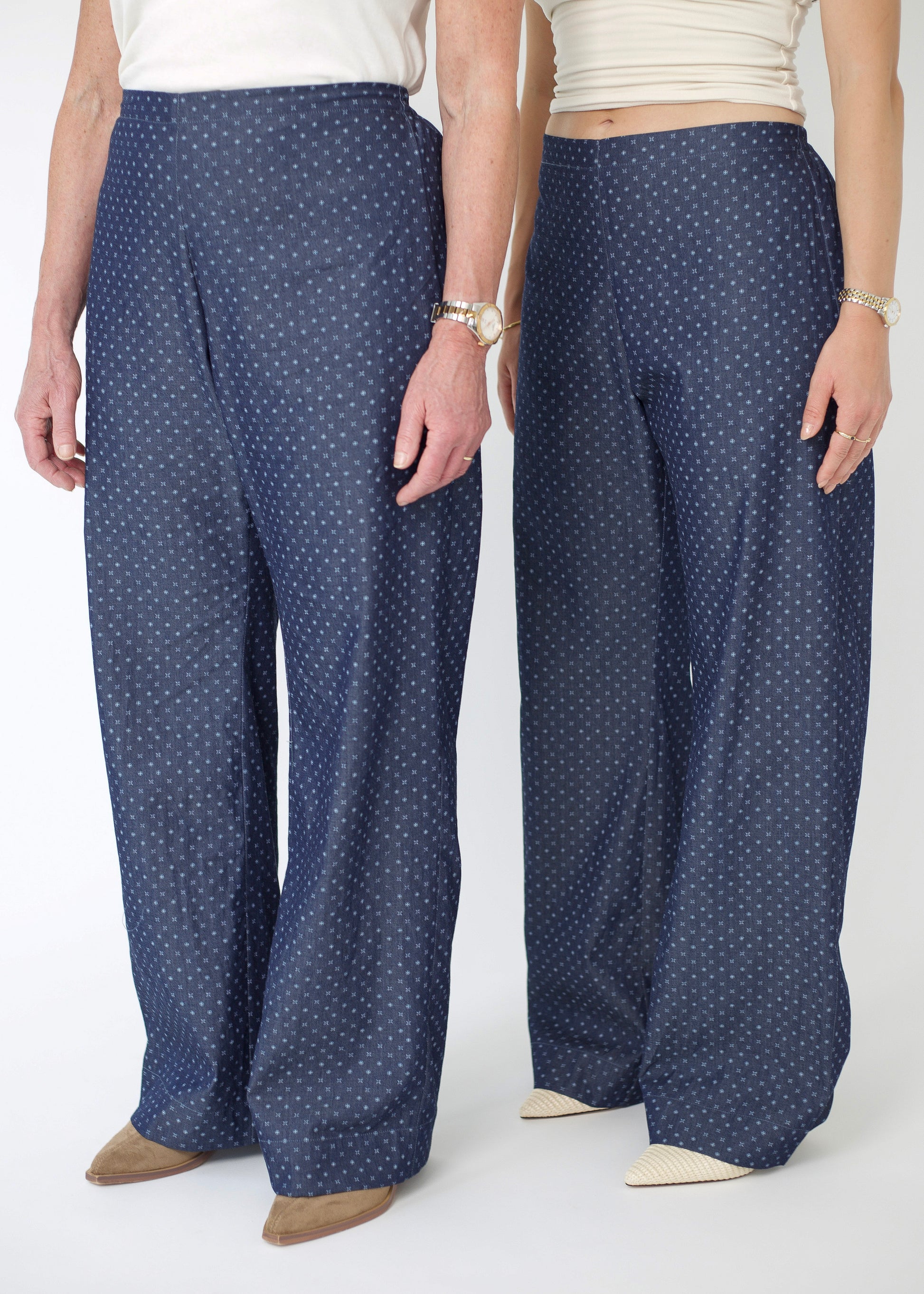 Person wearing blue polka dot pants on a white background