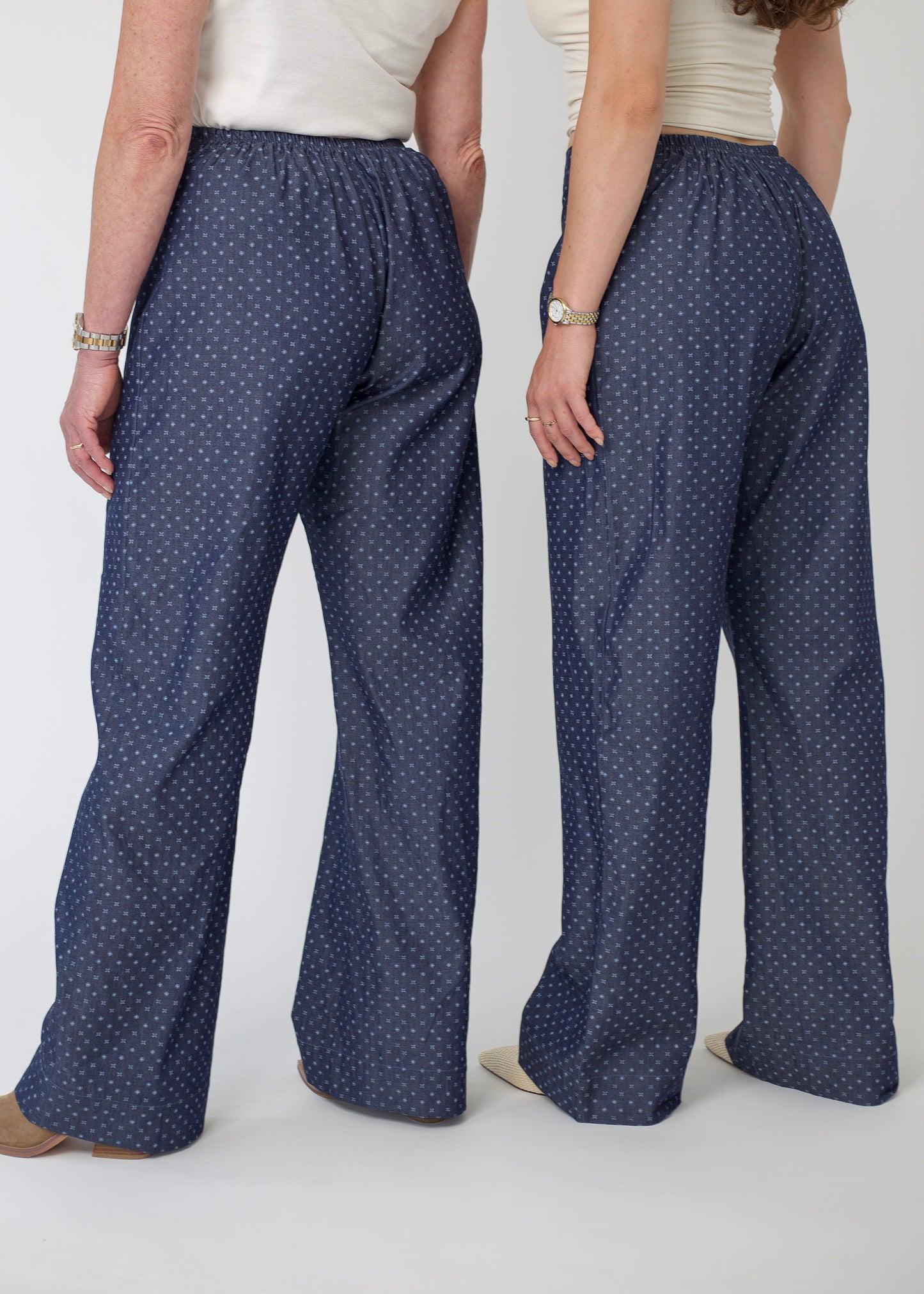 Person wearing blue patterned pants on a white background