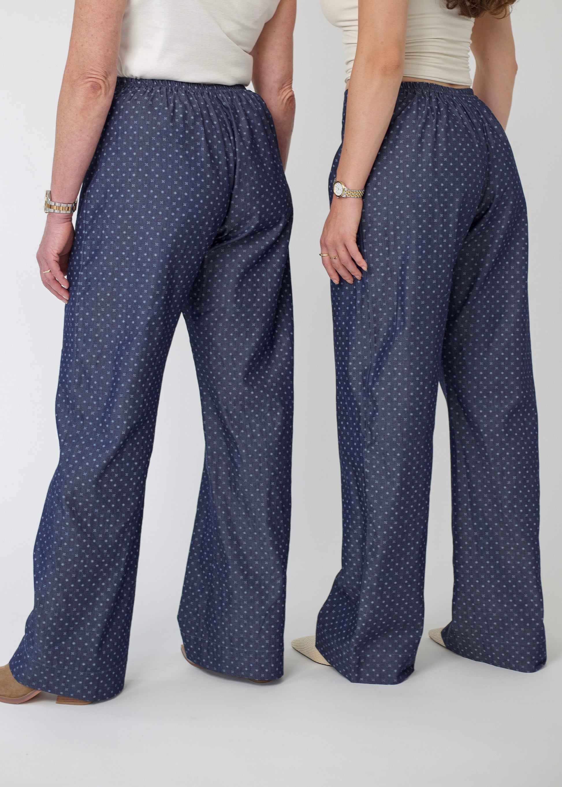 Person wearing blue patterned pants on a white background