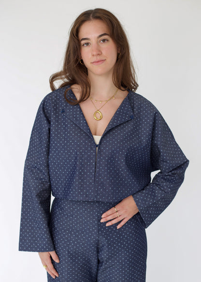 Woman wearing a blue polka dot outfit on a white background
